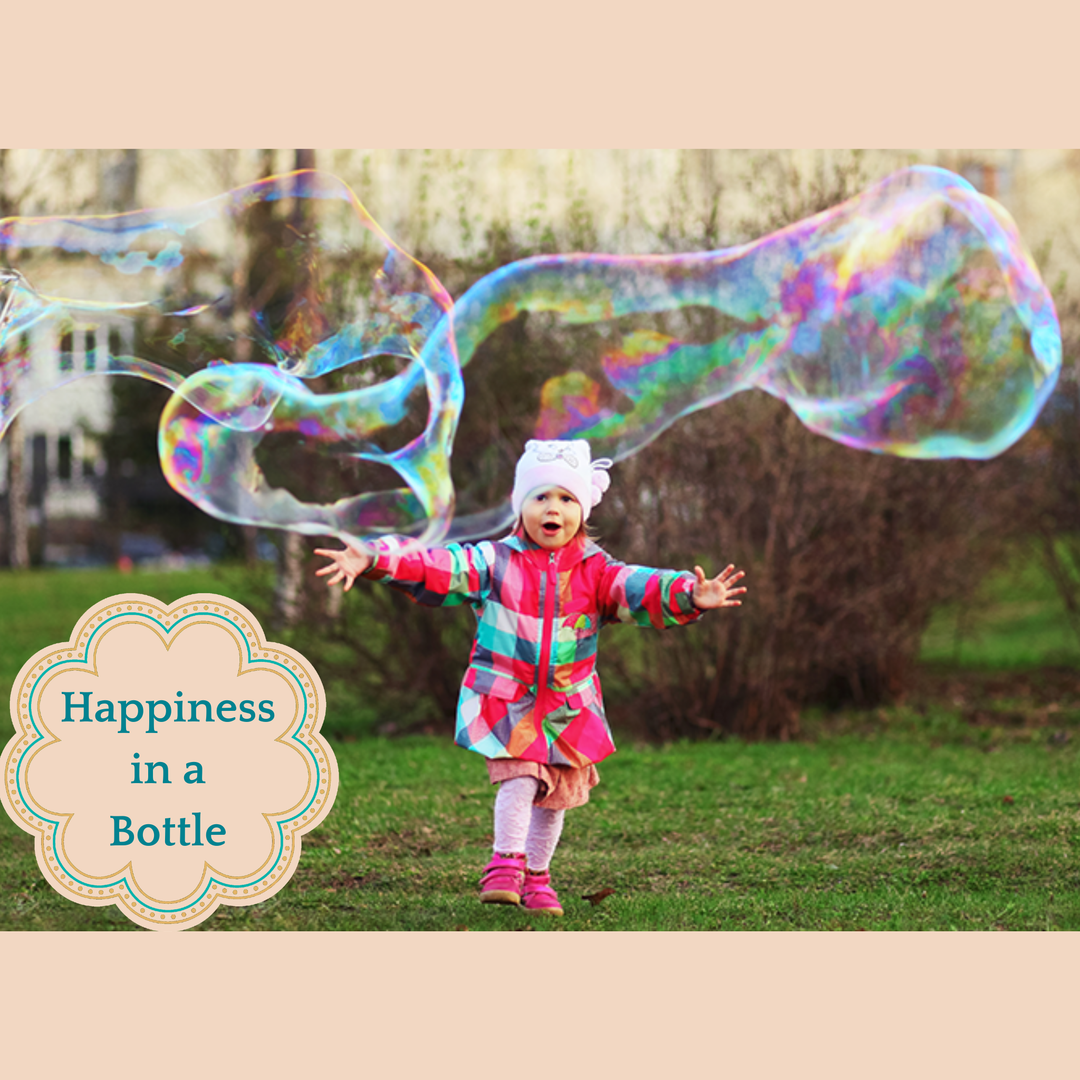 Child playing with large bubbles outdoors, with a text overlay 'Happiness in a Bottle'.