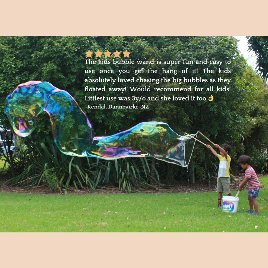 Two children playing with a large bubble wand in a park, with a five-star review above.